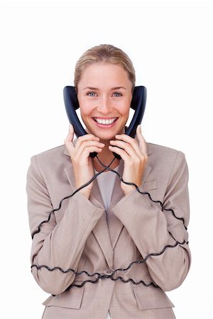 Smiling businesswoman tangled up in phone wires against a white background Stock Photo - Budget Royalty-Free & Subscription, Code: 400-04184296
