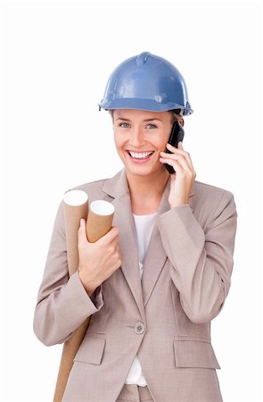 Self-assured female architect on phone standing against a white background Stock Photo - Budget Royalty-Free & Subscription, Code: 400-04184309