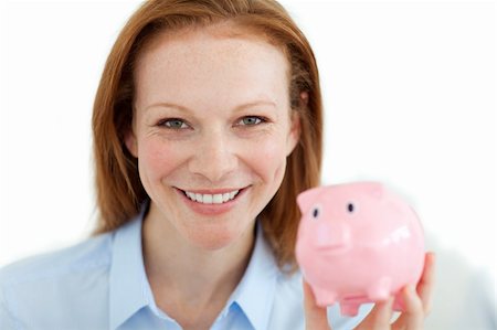 simsearch:400-05715207,k - Smiling businesswoman holding a piggybank against a white background Stock Photo - Budget Royalty-Free & Subscription, Code: 400-04184358