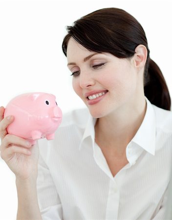 simsearch:400-05715208,k - Attractive businesswoman looking at a piggybank against a white background Stock Photo - Budget Royalty-Free & Subscription, Code: 400-04184459
