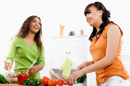 Stock image of two young women in kitchen preparing a salad Stock Photo - Budget Royalty-Free & Subscription, Code: 400-04184484