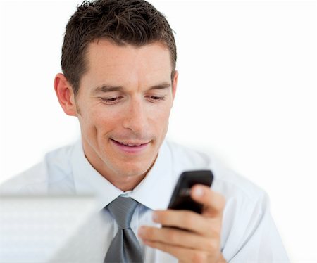 simsearch:400-05145011,k - Portrait of a businessman sending a text isolated on a white background Stock Photo - Budget Royalty-Free & Subscription, Code: 400-04184818