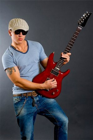 simsearch:400-04863651,k - Guitar player with sunglasses and hat playing his guitar Stock Photo - Budget Royalty-Free & Subscription, Code: 400-04185655