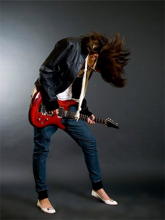 simsearch:400-04863651,k - passionate headbanging woman guitarist playing an electric guitar Stock Photo - Budget Royalty-Free & Subscription, Code: 400-04185659