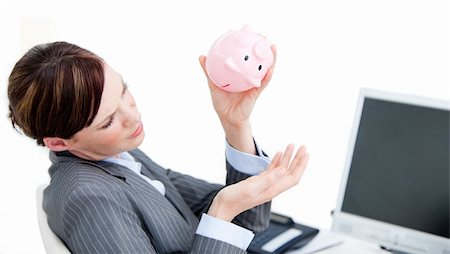 simsearch:400-04184165,k - Upset businesswoman holding a piggy-bank in the office Stock Photo - Budget Royalty-Free & Subscription, Code: 400-04186969