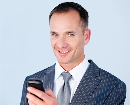 simsearch:400-05717420,k - Confident businessman sending a text with his  phone in the office Stock Photo - Budget Royalty-Free & Subscription, Code: 400-04186995