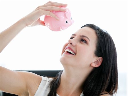 simsearch:400-04184165,k - Cute businesswoman looking at a piggybank  in the office Stock Photo - Budget Royalty-Free & Subscription, Code: 400-04187038