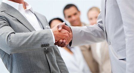 simsearch:400-04609965,k - Two businessmen shaking hand in front of their colleagues in the office Stock Photo - Budget Royalty-Free & Subscription, Code: 400-04187063