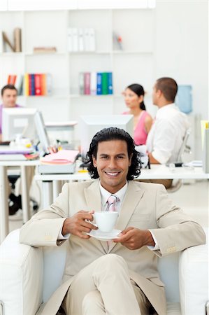 Ethnic manager drinking a coffee in the office Stock Photo - Budget Royalty-Free & Subscription, Code: 400-04187091