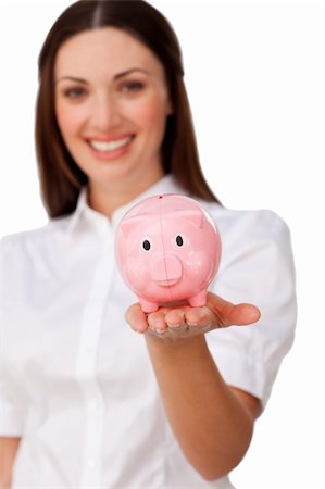 simsearch:400-05715208,k - Confident businesswoman showing a piggybank against a white background Stock Photo - Budget Royalty-Free & Subscription, Code: 400-04187479