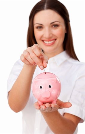 simsearch:400-04184165,k - Happy young businesswoman saving money in a piggybank against a white background Stock Photo - Budget Royalty-Free & Subscription, Code: 400-04187481