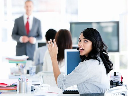 simsearch:400-05710382,k - Portrait of a interrested businesswoman raising her hand in the office Photographie de stock - Aubaine LD & Abonnement, Code: 400-04187841