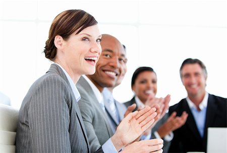 simsearch:400-05710382,k - Portrait of smiling businessteam applauding a presentation against a white background Photographie de stock - Aubaine LD & Abonnement, Code: 400-04187857