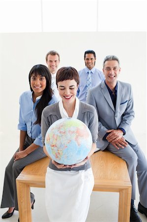 Positive international business people holding a terrestrial globe in the office Stock Photo - Budget Royalty-Free & Subscription, Code: 400-04187923