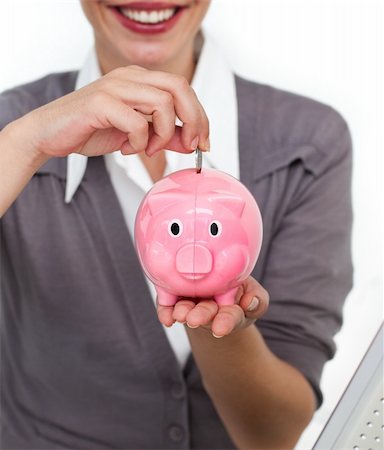 simsearch:400-04184165,k - Close-up of a businesswoman saving money in a piggybank isolated on a white background Stock Photo - Budget Royalty-Free & Subscription, Code: 400-04187999