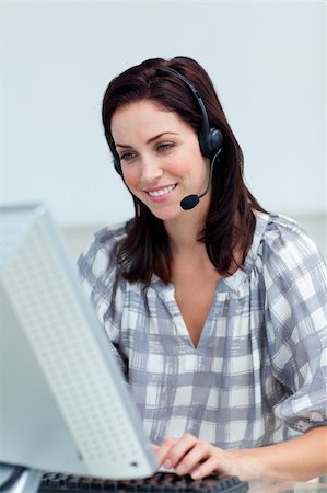 simsearch:400-05287143,k - Charming businesswoman with headset on working at a computer in a call-center Stock Photo - Budget Royalty-Free & Subscription, Code: 400-04188202