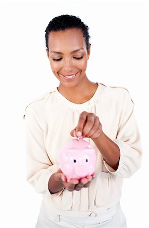 simsearch:400-04184165,k - Young Afro-american businesswoman saving money in a piggybank against a white background Stock Photo - Budget Royalty-Free & Subscription, Code: 400-04188276