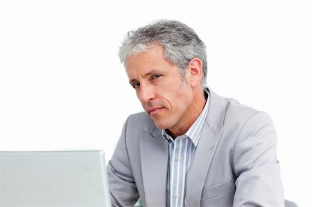 Portrait of a charming senior businessman working at a laptop Stock Photo - Budget Royalty-Free & Subscription, Code: 400-04188410