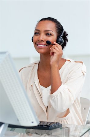 simsearch:400-05287143,k - Positive businesswoman with headset on working at a computer Stock Photo - Budget Royalty-Free & Subscription, Code: 400-04188451