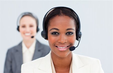simsearch:400-05287143,k - Ethnic businesswoman and her colleague with headset in a call center Stock Photo - Budget Royalty-Free & Subscription, Code: 400-04188594
