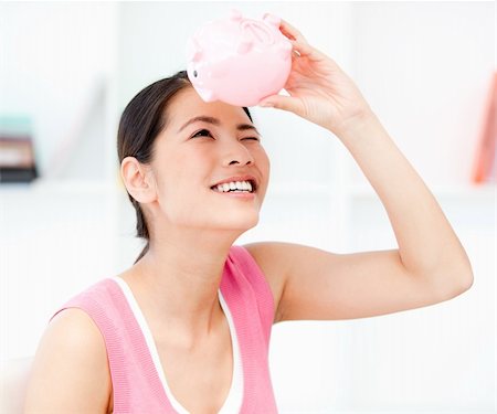 simsearch:400-04184165,k - Portrait of a smiling businesswoman holding a piggy-bank in the office Stock Photo - Budget Royalty-Free & Subscription, Code: 400-04189979