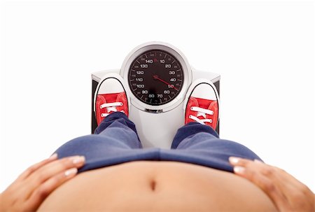 Athletic young girl measuring her weight on a balance Stock Photo - Budget Royalty-Free & Subscription, Code: 400-04180657