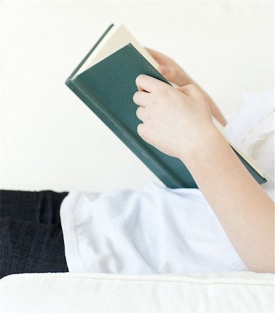 simsearch:400-04418460,k - Close-up of a woman reading a book lying on a sofa at home Stock Photo - Budget Royalty-Free & Subscription, Code: 400-04182648
