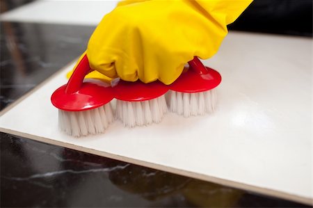 simsearch:400-04287497,k - Close-up of a person cleaning a bathroom's floor with a red brush Stock Photo - Budget Royalty-Free & Subscription, Code: 400-04182667
