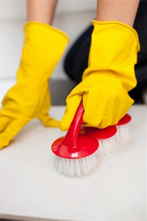 simsearch:400-08693600,k - Close-up of a woman cleaning a bathroom's floor with a yellow rubber glove Stock Photo - Budget Royalty-Free & Subscription, Code: 400-04182669