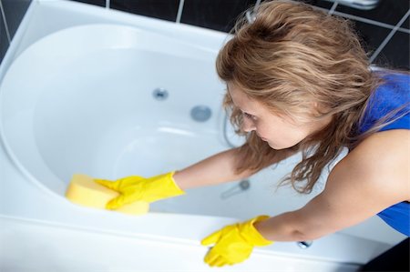 simsearch:400-08693600,k - Young woman cleaning a bath with a sponge Stock Photo - Budget Royalty-Free & Subscription, Code: 400-04182661