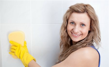 simsearch:400-08693600,k - Smiling woman cleaning a bathroom with a sponge Stock Photo - Budget Royalty-Free & Subscription, Code: 400-04182673