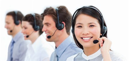 Portrait of smiling customer service agents working in a call center against a white background Stock Photo - Budget Royalty-Free & Subscription, Code: 400-04183014