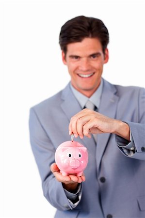 simsearch:400-04184165,k - Cheerful businessman saving money in a piggy-bank against a white background Stock Photo - Budget Royalty-Free & Subscription, Code: 400-04183085