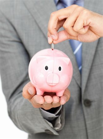 simsearch:400-04184165,k - Close-up of a businessman saving money in a piggy-bank against a white background Stock Photo - Budget Royalty-Free & Subscription, Code: 400-04183124