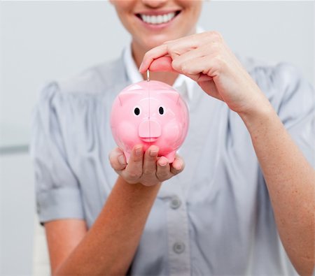 simsearch:400-05715208,k - Close-up of a smiling woman holding a piggy bank Stock Photo - Budget Royalty-Free & Subscription, Code: 400-04183549