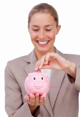 simsearch:400-04184165,k - Smiling businesswoman saving money in a piggybank isolated on a white background Stock Photo - Budget Royalty-Free & Subscription, Code: 400-04183714