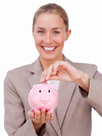 simsearch:400-05715208,k - Smiling businesswoman looking at the camera holding a piggy bank Stock Photo - Budget Royalty-Free & Subscription, Code: 400-04183715