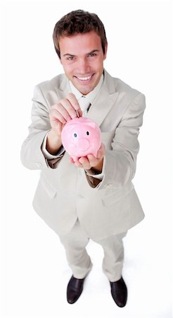 simsearch:400-04184165,k - Charismatic businessman saving money in a piggybank against a white background Stock Photo - Budget Royalty-Free & Subscription, Code: 400-04183754
