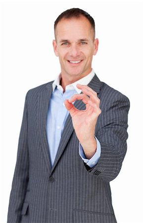 simsearch:400-04875087,k - Charismatic businessman showing OK sign against a white background Photographie de stock - Aubaine LD & Abonnement, Code: 400-04183872