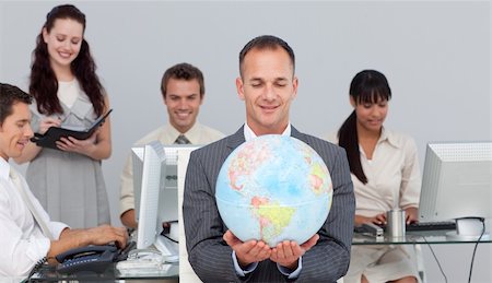 equality background hands - Charsmatic manager smiling at global expansion with his team in the background Stock Photo - Budget Royalty-Free & Subscription, Code: 400-04183950
