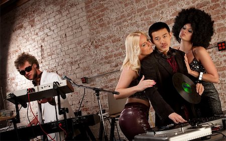 dancing piano - Pretty ladies surrounding a DJ at a 1970s Disco Music Party Photographie de stock - Aubaine LD & Abonnement, Code: 400-04194131