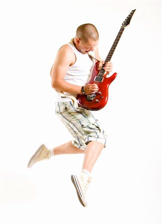 passionate guitarist jumps in the air over white Stock Photo - Budget Royalty-Free & Subscription, Code: 400-04194421