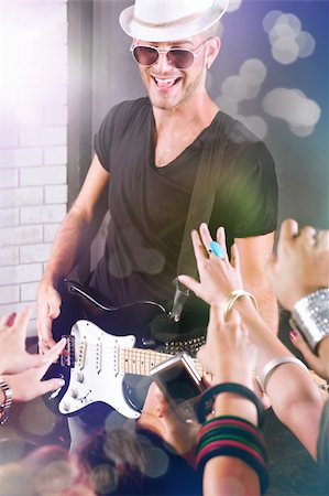 A guitarist performing for his adoring fans at  dico club or party Photographie de stock - Aubaine LD & Abonnement, Code: 400-04195475