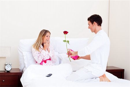 Affectionate husband giving a present to his wife in the bedroom Stock Photo - Budget Royalty-Free & Subscription, Code: 400-04195866