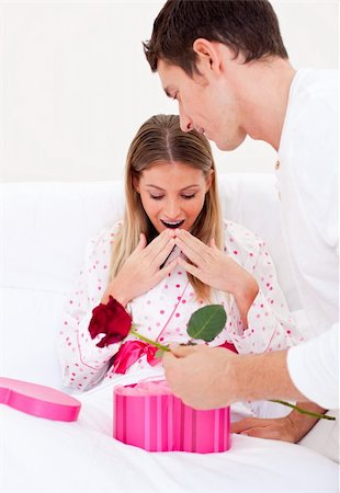 Bright husband giving a present to his wife in the bedroom Stock Photo - Budget Royalty-Free & Subscription, Code: 400-04195863