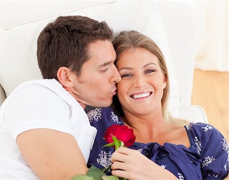 simsearch:400-04195864,k - Portrait of a charming man kissing his wife lying on sofa at home Stock Photo - Budget Royalty-Free & Subscription, Code: 400-04195962