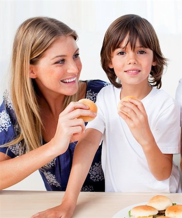 simsearch:400-04193348,k - Attractive mother and her son eating burgers  in the living room Stock Photo - Budget Royalty-Free & Subscription, Code: 400-04195989