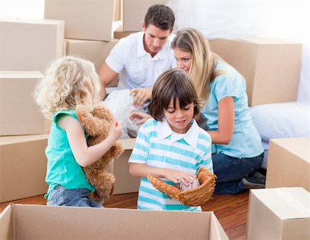 Caucasian family packing boxes while moving house Stock Photo - Budget Royalty-Free & Subscription, Code: 400-04195996