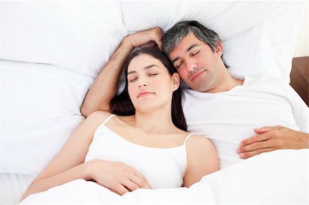 simsearch:400-04195864,k - Affectionate couple hugging lying in their bed at home Stock Photo - Budget Royalty-Free & Subscription, Code: 400-04196895