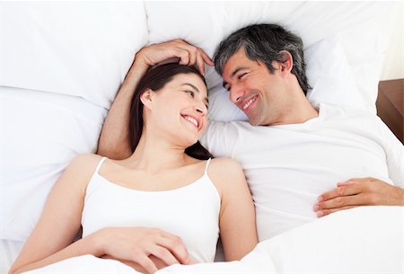 simsearch:400-04195864,k - Enamored couple hugging lying in their bed at home Stock Photo - Budget Royalty-Free & Subscription, Code: 400-04196896